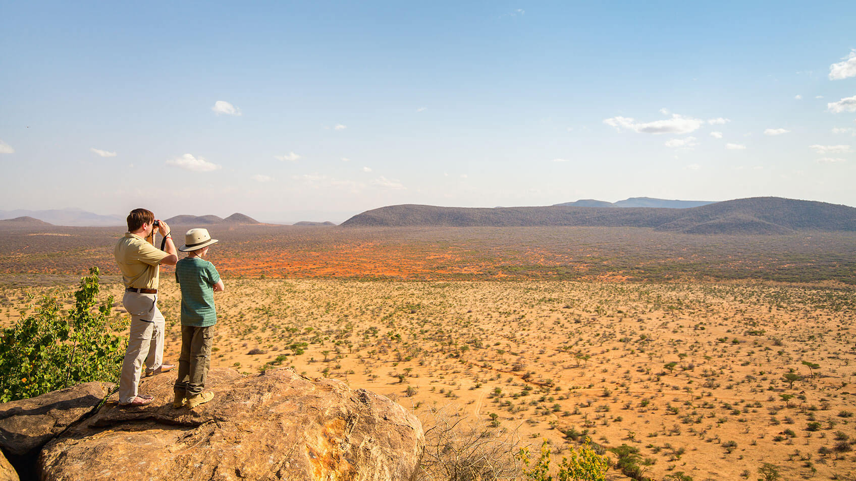 two-people-looking-at-hills
